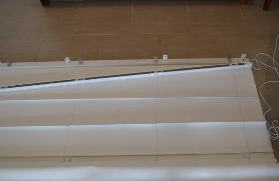 Roman blind on floor with disconnected headrail winder mechanism Roman blind on floor with disconnected headrail winder mechanism